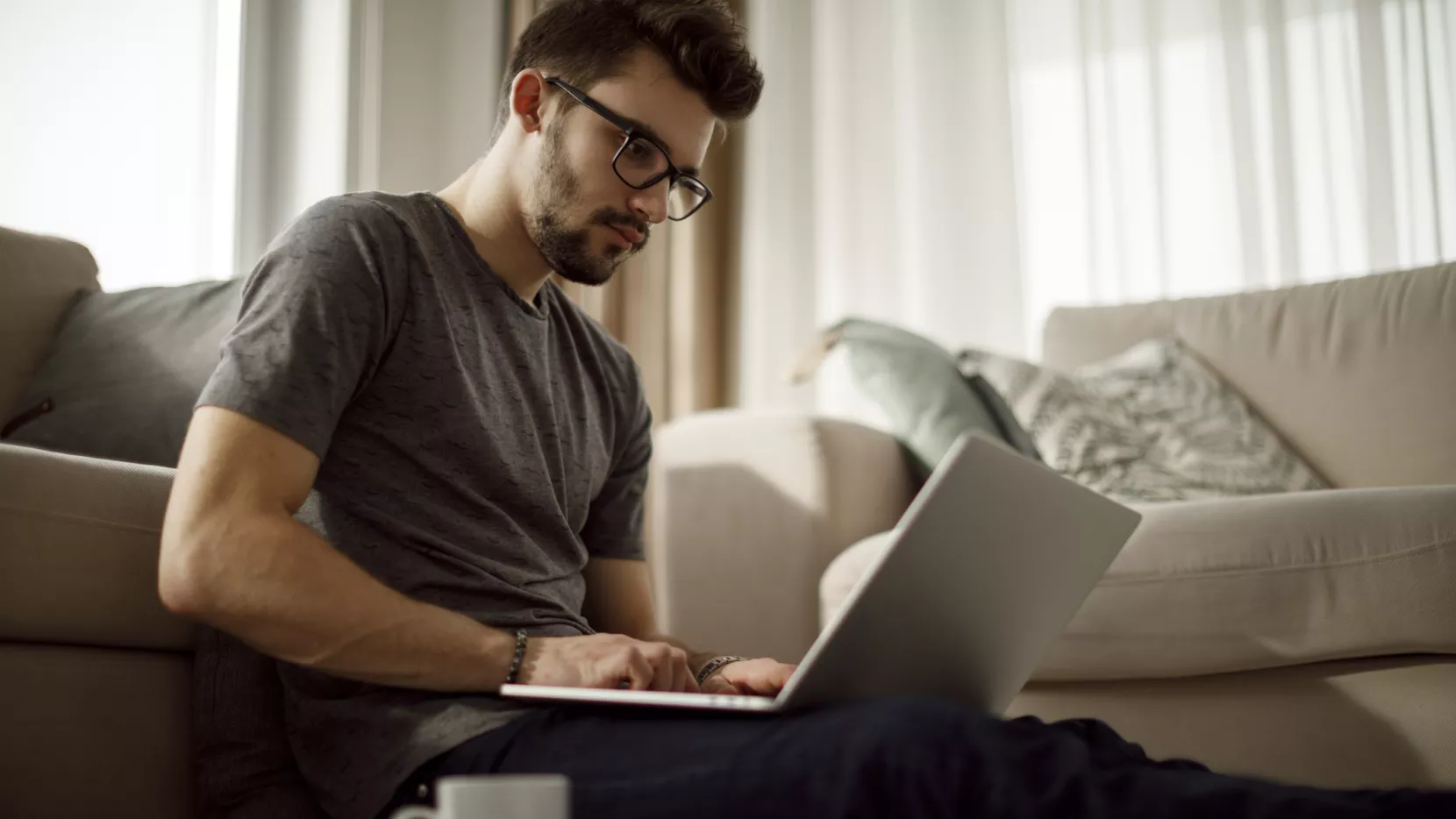 Beeld bij UWV-webinars, een man werkt op zijn laptop
