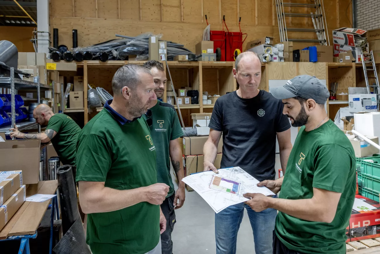 Abdel Munir na scholing voor installatietechniek in overleg met collega's